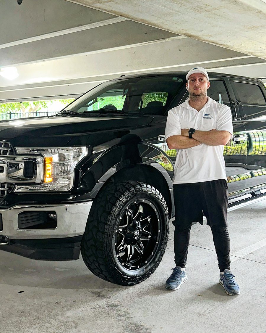 Milton Santos, owner of Pro Polishing MIA, standing beside his truck