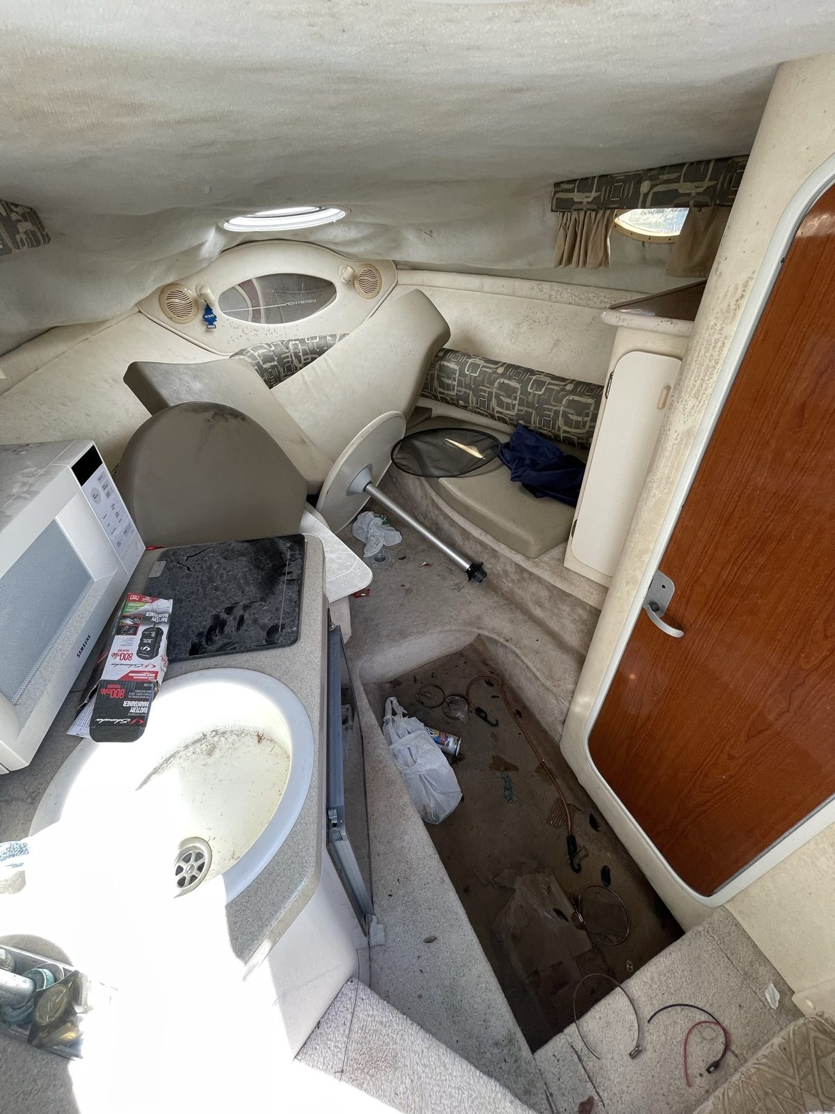 Cluttered, grimy boat cabin interior before deep cleaning