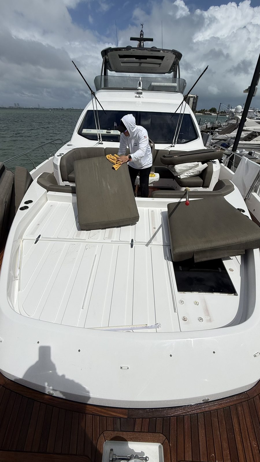 Crew member detailing flybridge cushions
